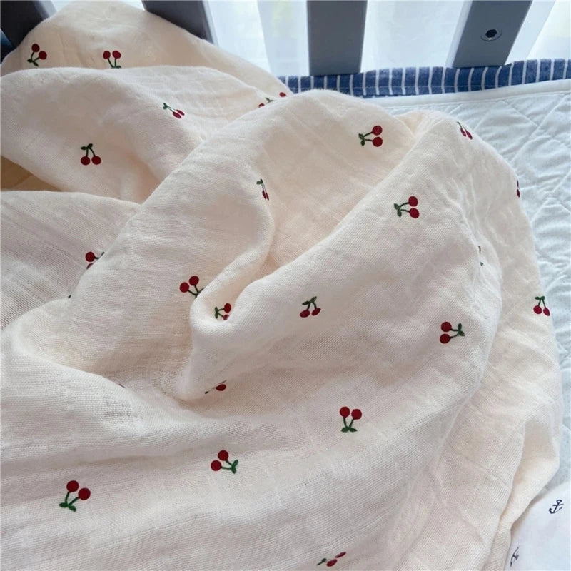 Large cream cotton muslin swaddle wrap with small cherry print
