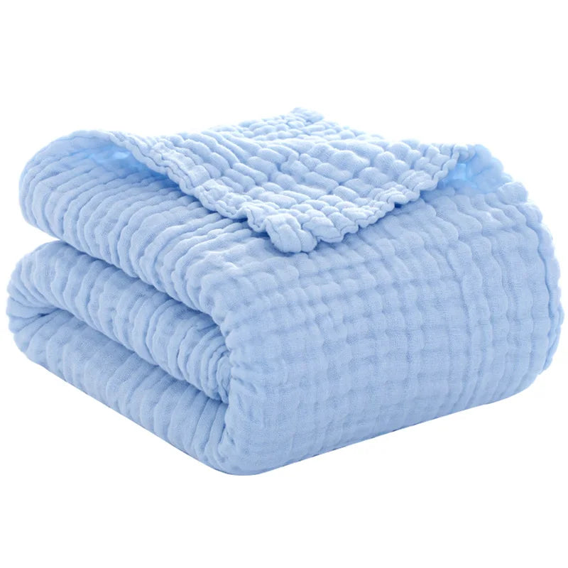 Folded soft blue cotton swaddle blanket