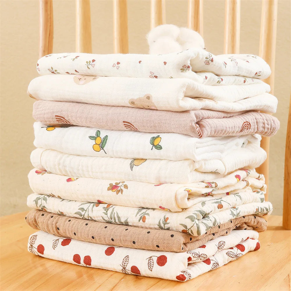 Stack of printed cotton muslin squares in soft neutral colours