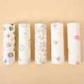 Five rolled cotton muslin swaddle blankets in soft prints