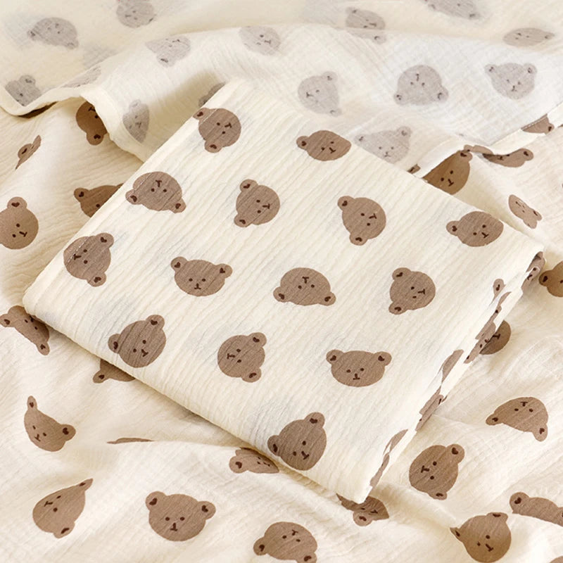 Two-layer cotton muslin baby bath blanket in cream with small print